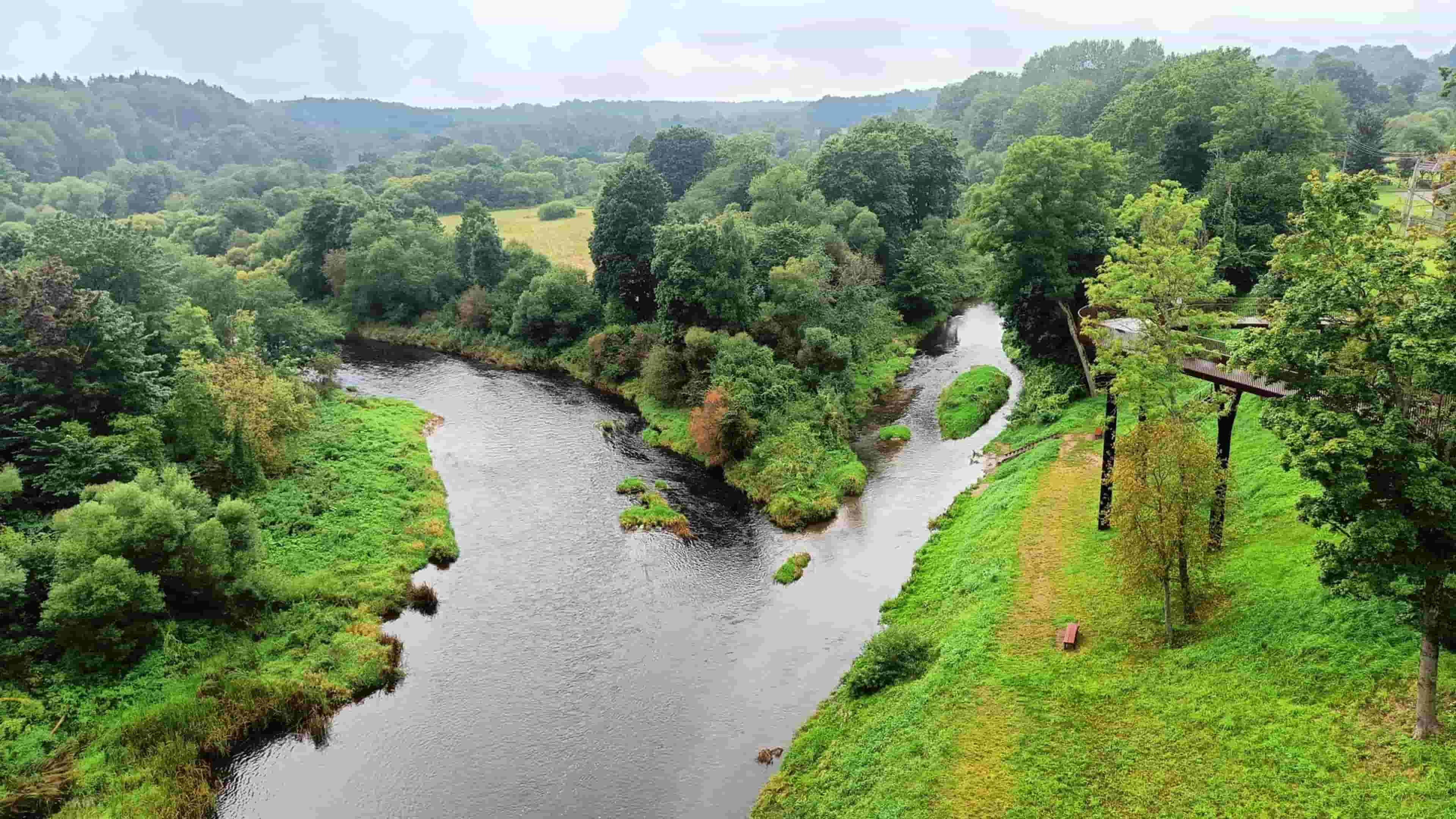 The image shows the confluence of the Jūra and Akmena rivers as viewed from the Pagramantis observation tower in Lithuania