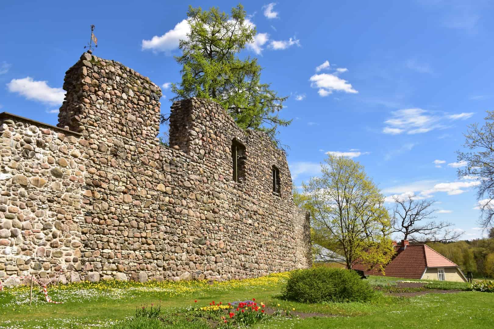 The image shows the ruins of Valmiera Castle, a medieval fortress in Valmiera, Latvia