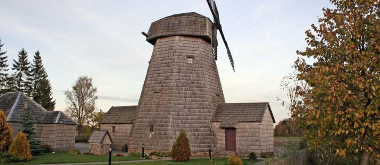 The image features the historic Purpliai windmill in Mažeikiai