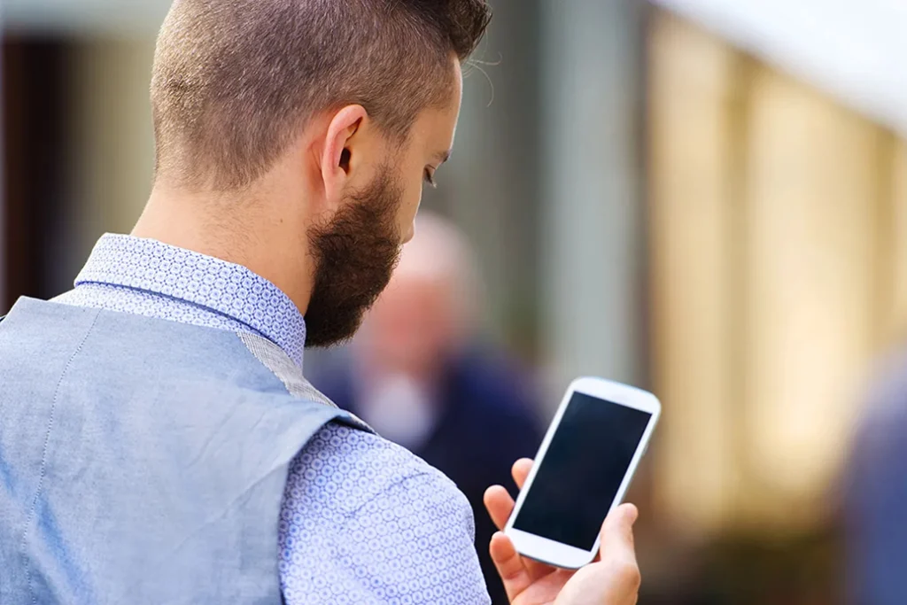 Man using smartphone outdoors