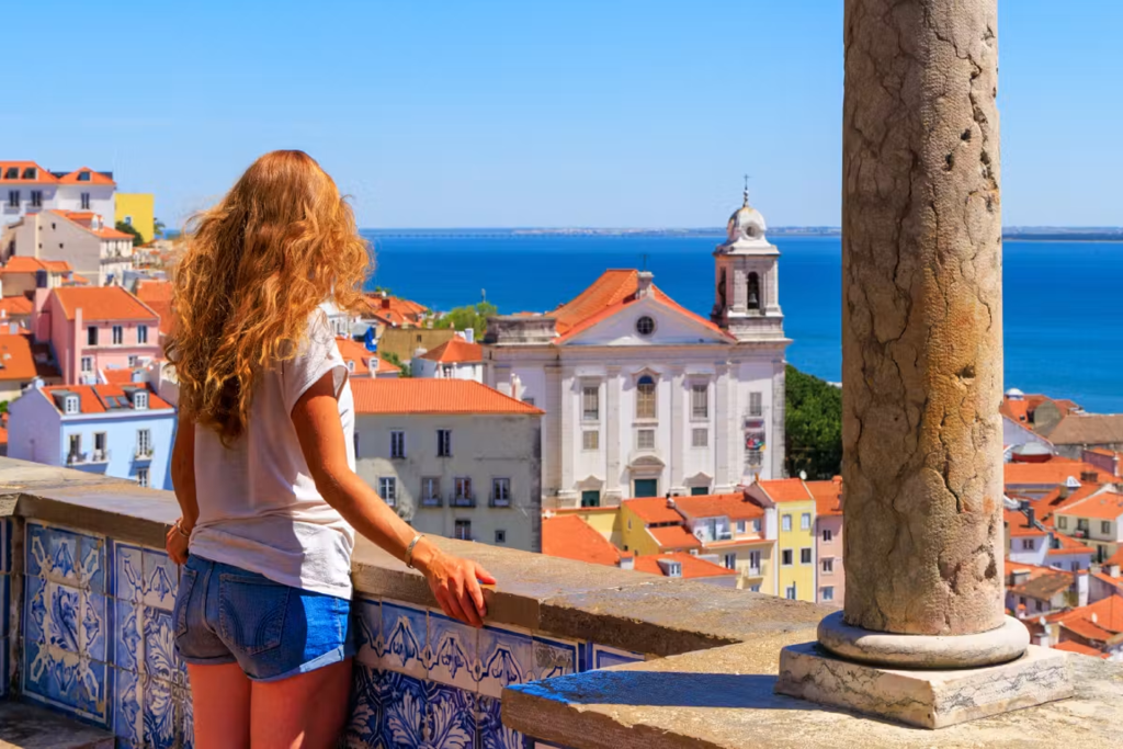 Girl overlooking a coastal city in Portugal