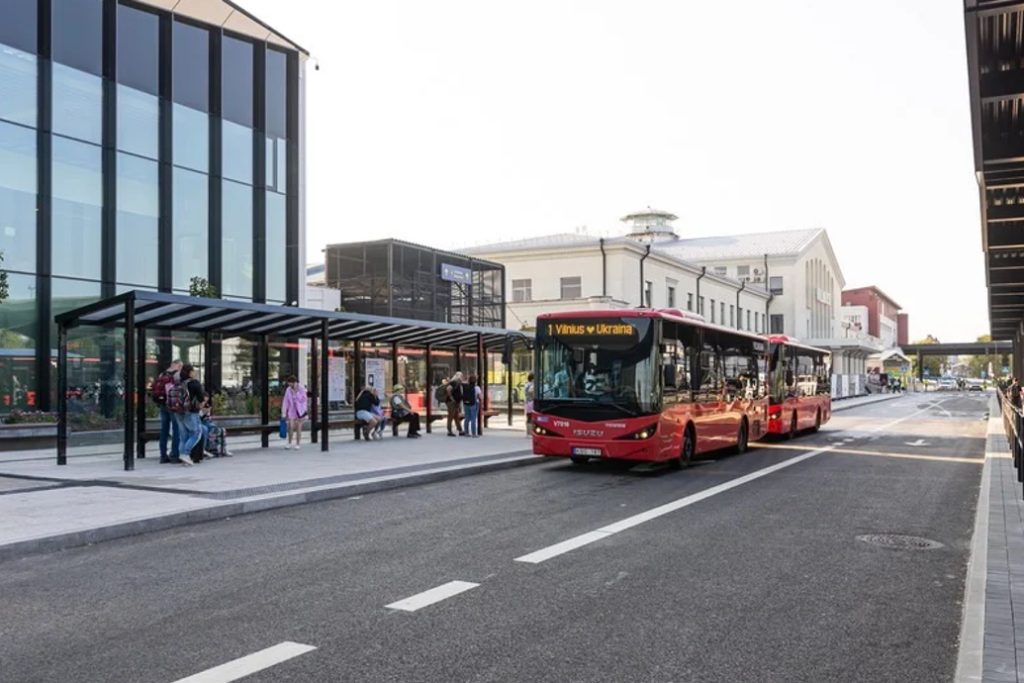 Red city buses at a public transport station in Vilnius.