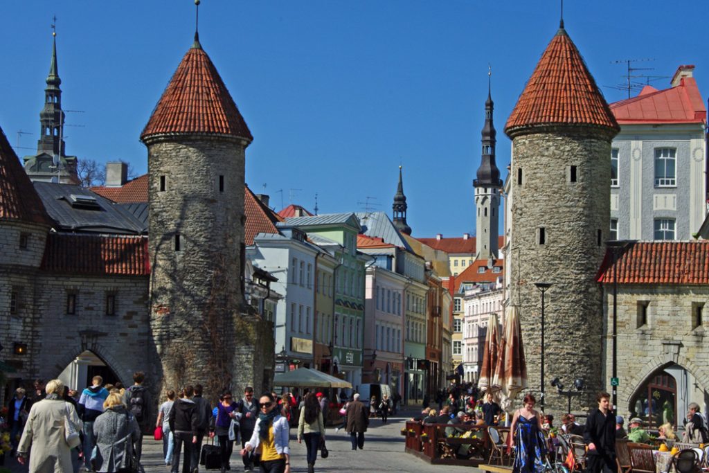 Medieval stone towers and tourists in Tallinn Old Town.