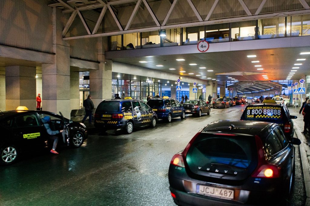 Taxis waiting outside an airport terminal in Lithuania.