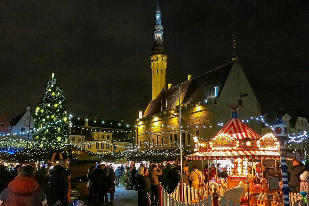 Christmas market with a carousel and festive lights in Tallinn Old Town.