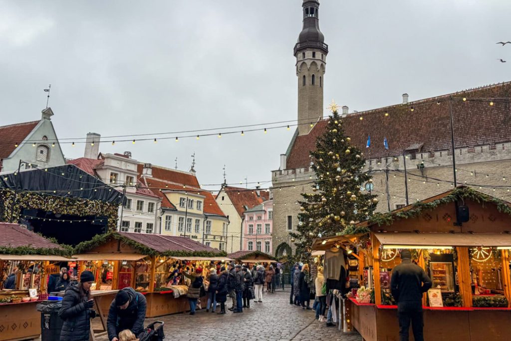 Visitors shopping at Tallinn Christmas Market near Town Hall.